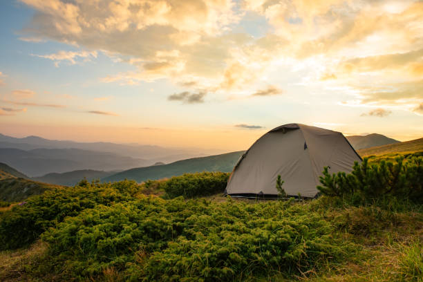 istock Tourist tent in sunset mountains 1126876659