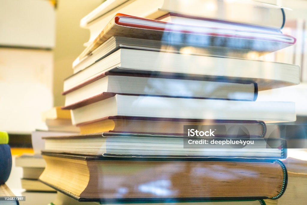 A stack of books in the library by the window Book Stock Photo