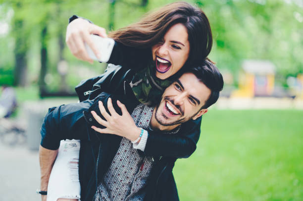 istock Couple on piggyback taking selfie 1126878399