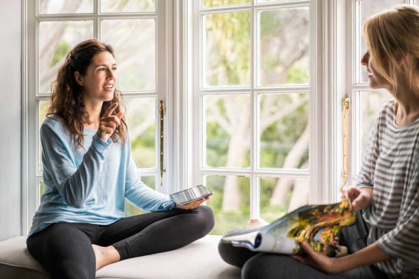 istock Friends are talking at alcove window seat 1126878535