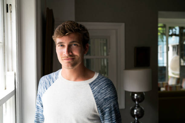 istock Portrait of smiling young man at home 1126879449