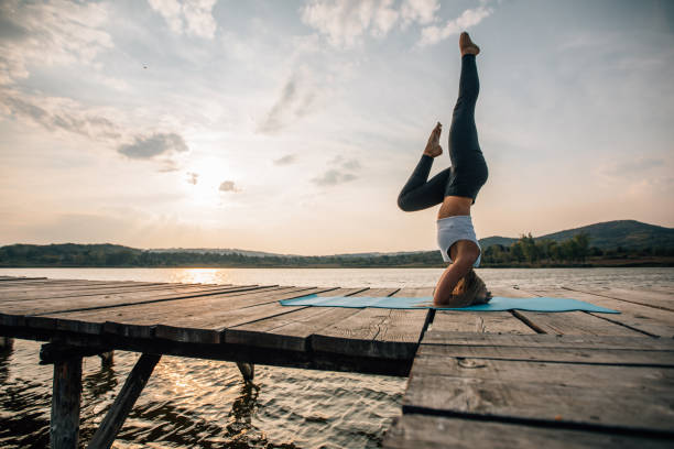istock Woman doing yoga at the lake 1126879643