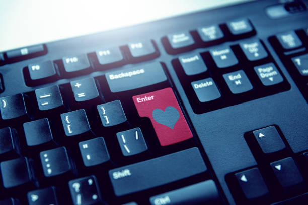 istock Red button on the keyboard with a heart enter online love. 1126882803