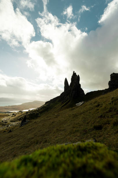 istock Old Man of Storr as seen from a higher viewpoint with dramatic sky and bright sun (Isle of Skye, Scotland, United Kingdom) 1126883200