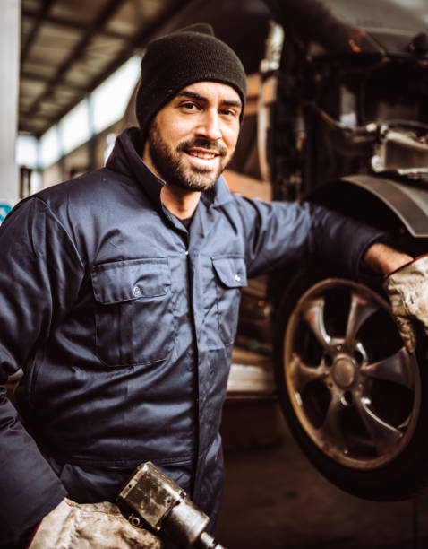 istock mechanic man repair a tire 1126883209