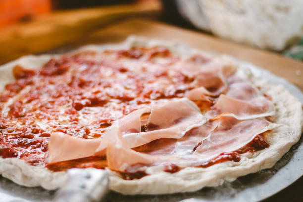 istock Woman making original italian pizza at home. 1126884564