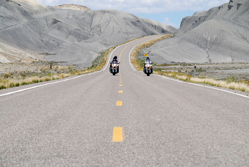 riding motorbikes on empty highway in Utah