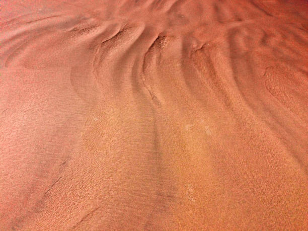 istock patterns from the waves and wind on the sand, sand of an unusual color 1126884782