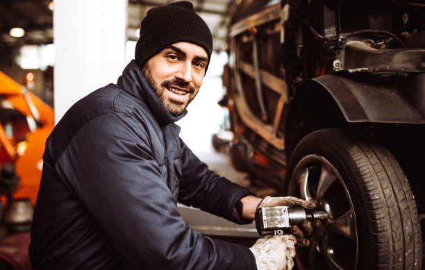 istock mechanic man repair a tire 1126886065
