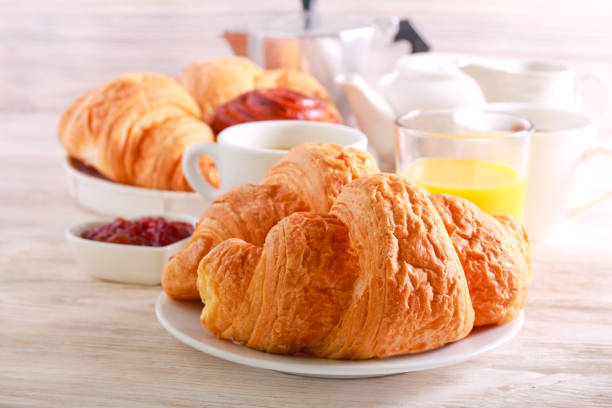 istock Breakfast, with croissant, juice and coffee 1126888656