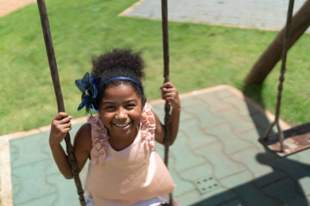 istock Happy girl swinging 1126888672