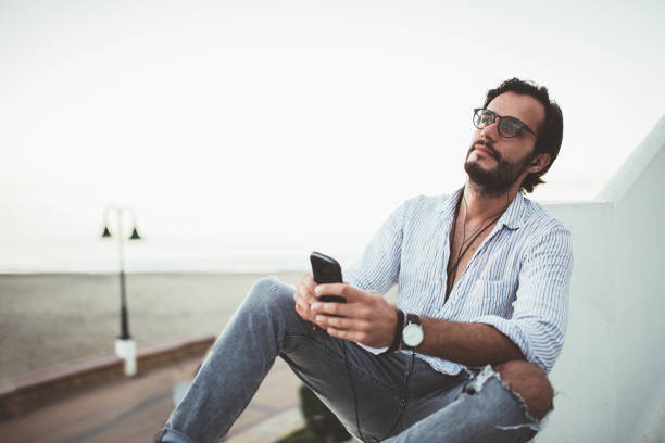 istock Young man listening to music 1126890373