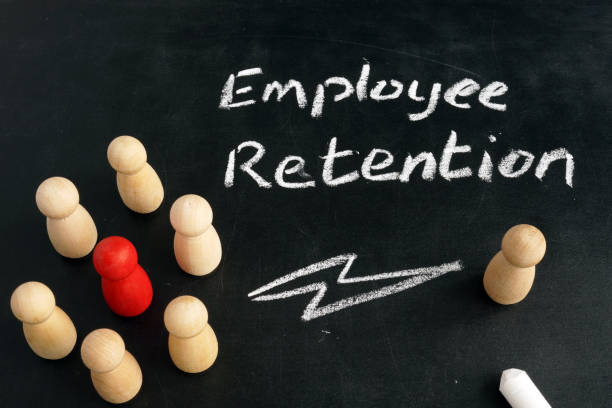istock Employee Retention. Wooden figurines on a blackboard. 1126892346