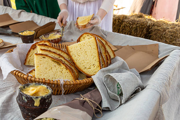 medieval fast food slice of bread large rustic loaf ceramic bowl of honey and lard with garlic nourishing additive delicious snack
