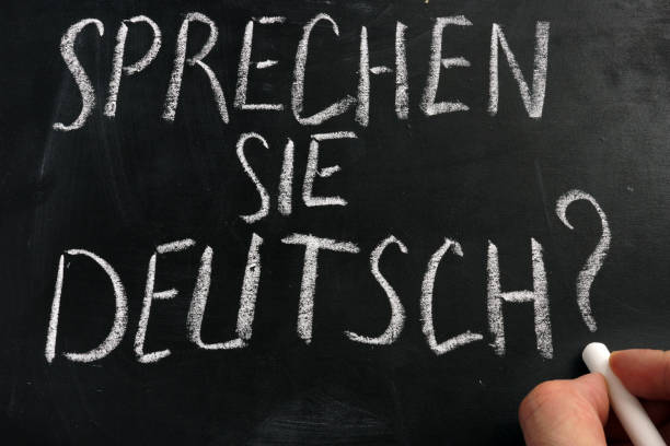 istock Learn German concept. Sprechen Sie Deutsch sign on a blackboard. 1126892621