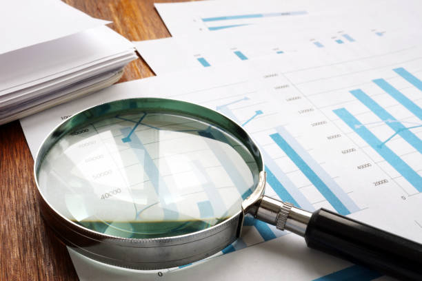 istock Audit and accounting concept. Magnifier and business papers. 1126892628