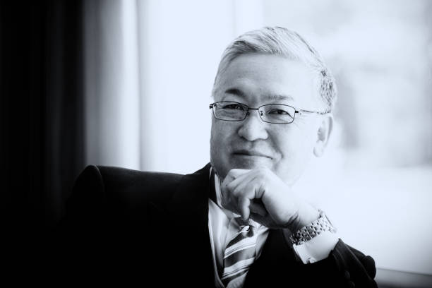 istock A handsome senior Asian man smiling into the camera in formal clothes 1126897340