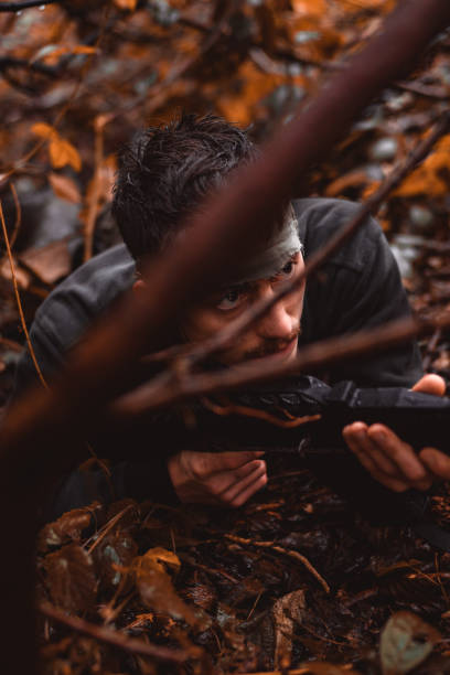 istock İnsurgent lying on the ground in the forest 1126897461