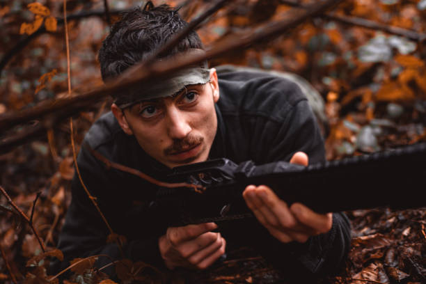 istock İnsurgent lying on the ground in the forest 1126897842