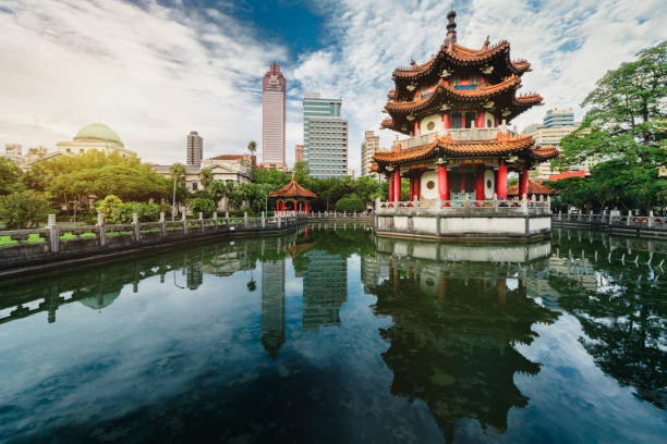 228 national park in Taipei, Taiwan Sunset of 228 national park with modern building and pond reflection, Taipei, Taiwan taiwan stock pictures, royalty-free photos & images