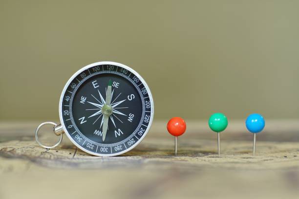 istock Compass and marking pins on blur vintage world map, journey concept, copy space 1126904822