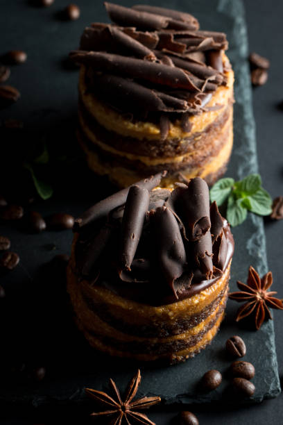istock Chocolate cakes on black slatter board with mint, coffee beans on dark background, closeup photo. Fresh, tasty dessert food concept. 1126906749
