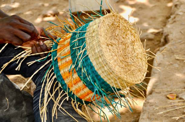 istock Midsection Of Craftsperson Weaving Basket 1126907735
