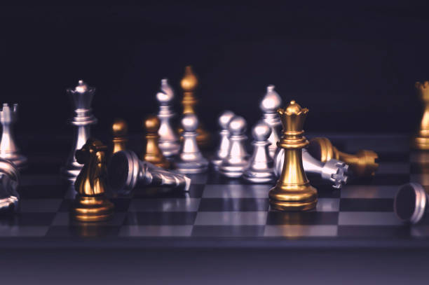 istock Chess pieces knights facing each other for a standoff. Chess knights confronting each other. 1126907799