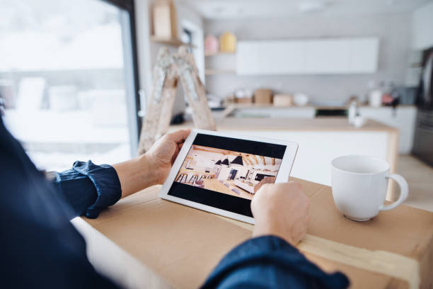 istock Midsection of man with tablet, looking at interior design sketches. A new home concept. 1126908083