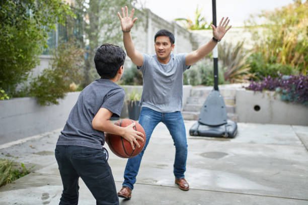 istock Father and son playing basketball at yard 1126908493