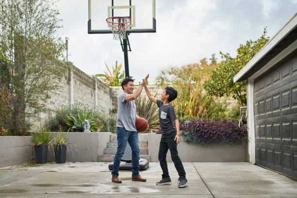 istock Father and son celebrating while playing basketball 1126908565