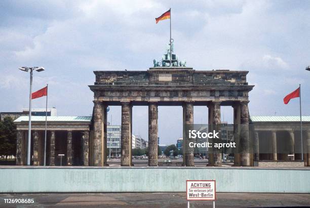 Historic Image From July 1980 A Look From West Berlin Over The Berlin Wall To Brandenburg Gate And East Berlin Sign With Caution You Are Leaving West Berlin In The Foreground Scanned Slide Stock Photo - Download Image Now