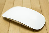 White Wireless mouse on wood table