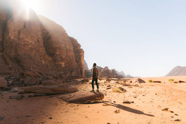 istock Man looking at  Wadi Rum desert from rock 1126913971
