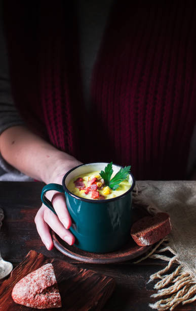 istock Mug with soup in female hands. 1126915807