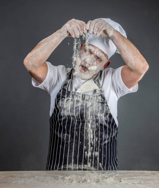 istock chef in chef's whites covered in flour 1126916605