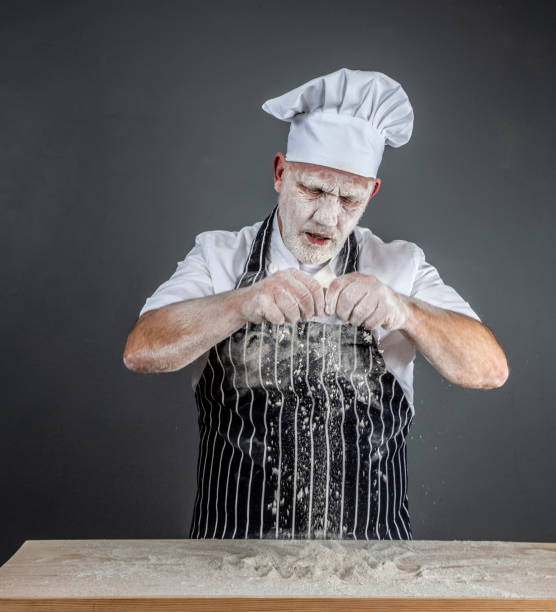 istock chef in chef's whites covered in flour 1126916612