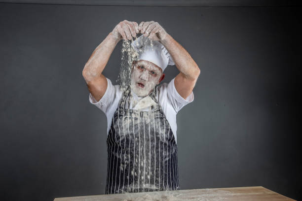 istock chef in chef's whites covered in flour 1126916619