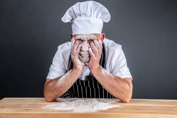 chef in chef's whites covered in flour chef in chef's whites covered in flour slapstick comedy stock pictures, royalty-free photos & images