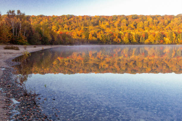 A view of South Bar Lake and Lake Michigan, as seen from Empire Bluff Trail. Sleeping Bear Plateau, part of Sleeping Bear Dunes is a dominant part of the scene. South Manitou Island can be seen in the distance.
