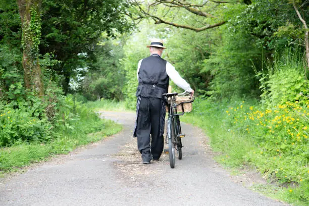 Photo of grocer on old bicycle with basket