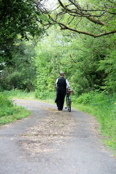 Photo of grocer on old bicycle with basket