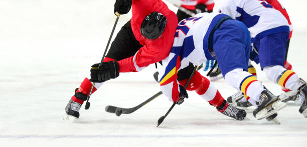 istock Ice Hockey Players On Ice Rink 1126917881