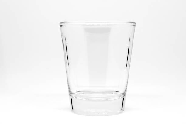 Empty small shot glass isolated on white background. stock photo