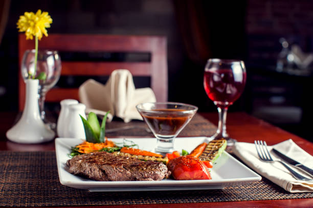 Beef steak with grilled vegetables served on white plate