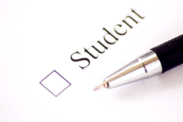 istock Student - checkbox with a cross on white paper with pen. Checklist concept. 1126922879