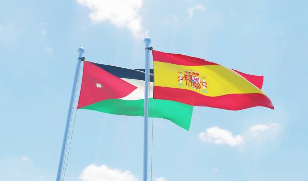 istock Spain and Jordan, two flags waving against blue sky 1126924208