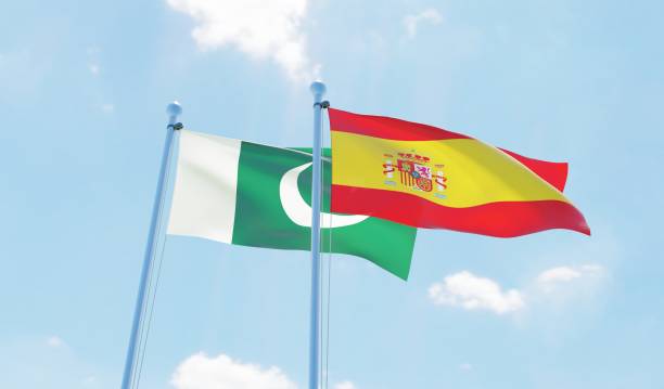 istock Spain and Pakistan, two flags waving against blue sky 1126924332