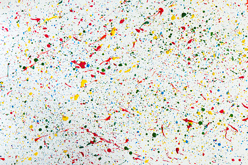 Abstract background from splashes of colorful dots of paint.