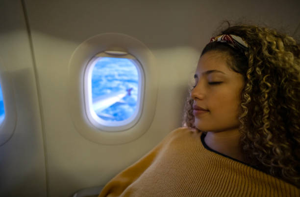 istock Traveling woman sleeping on an airplane 1126924504